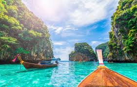 A stunning view of Thailand's turquoise coastline, with crystal-clear waters and tropical islands in the background.