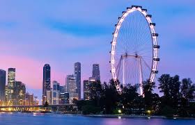 The Singapore Flyer observation wheel towering above the city with panoramic views of Marina Bay and the skyline at sunset.