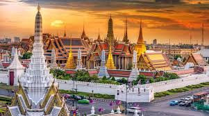 Ornate buildings of the Grand Palace in Bangkok with golden spires and detailed architecture.