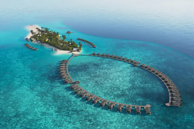 "Aerial view of Veligandu Island Maldives with overwater villas and turquoise lagoon"