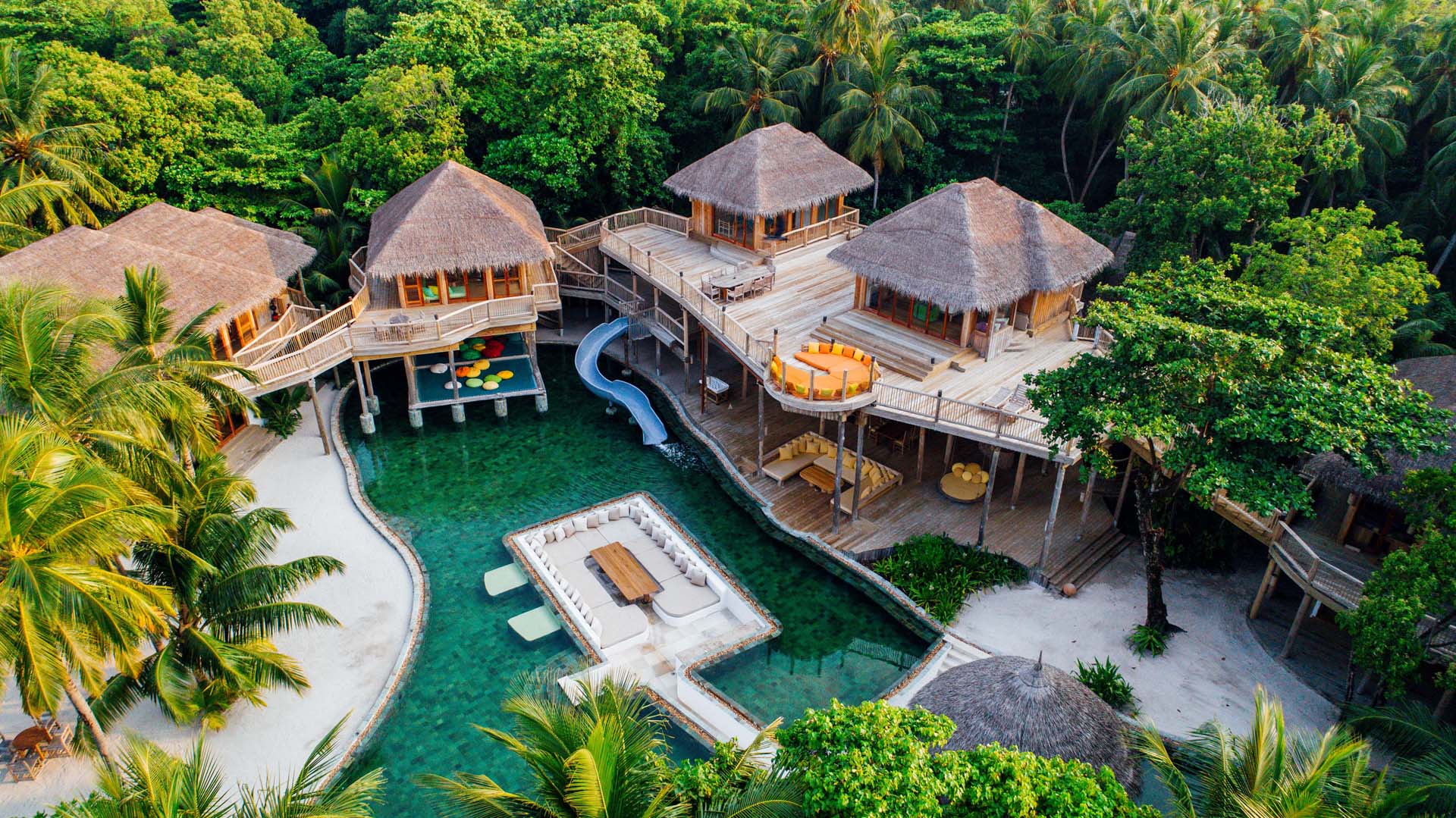 Overwater villa at Soneva Fushi, Maldives, featuring a private pool and water slide